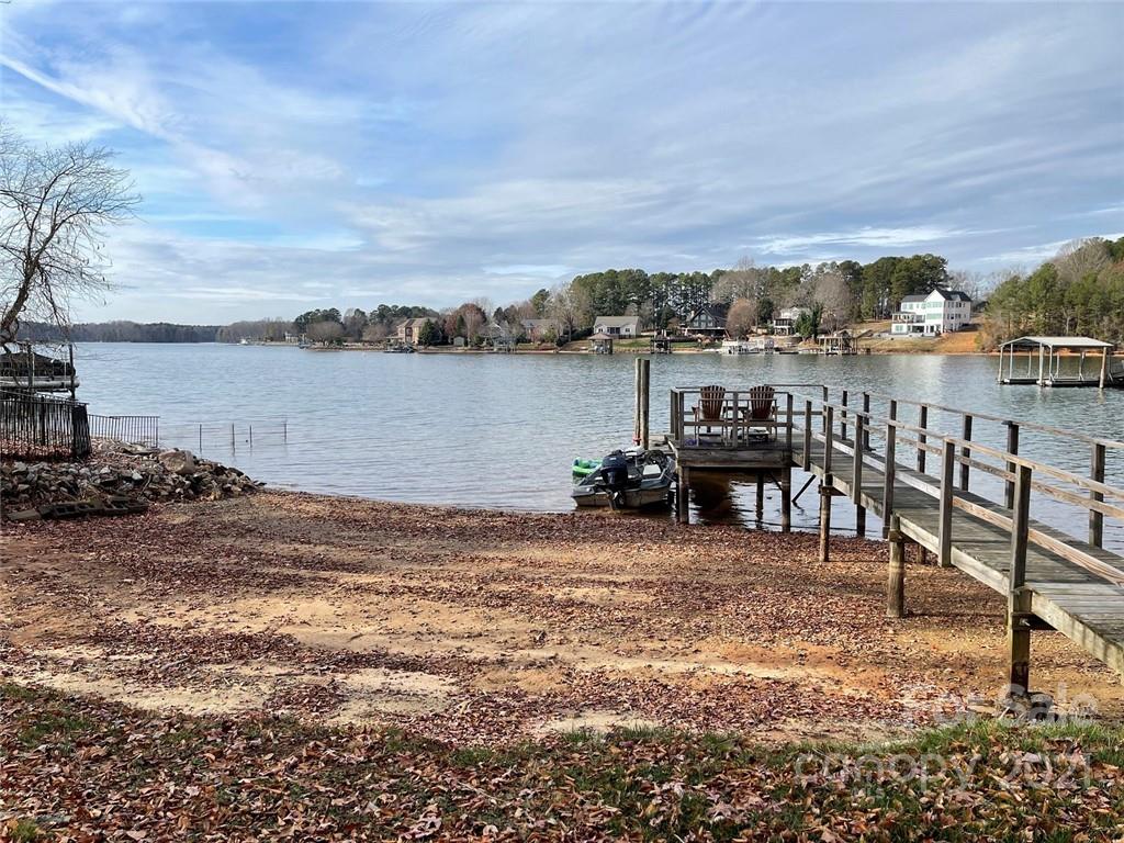 Water, water everywhere!  Beautiful big water location and views with this waterfront cottage, in the culdesac on one of the best waterfront locations in Sherrills Ford, just a couple homes off the point that is Riviera Drive.  Gently sloping lot has a beach area and pier/dock.  Home has 2 bedrooms/2 baths on the main level, and 1 bedroom/1 full bath in the basement, although home is only currently permitted for 2 bedrooms.  Owner has had a soil scientist out to verify that the septic could be expanded to 3 bedrooms (see media attachments).  Open floorplan with spacious greatroom upstairs and also a huge rec room downstairs.  Tenant in place, so buy this one to renovate/expand current home or build your dream home on later.  Big water locat