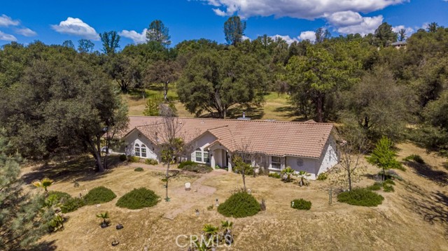 Where can you get 10+/- usable acres with a seasonal stream running through the property in the middle of Oakhurst? Meandering up your driveway, this home is located very close to Yosemite High School, all while maintaining privacy and not really seeing any neighbors from you home. A very nice offering with a large family room/game room for entertainment. Be sure to check this home out with all of the open living space, walk-in pantry, 4th bedroom and bath located at the opposite end of the home, makes for a great in-law set up. French door to the covered patio is very close to this bedroom as well. The back patio area and yard is fenced for your animals so to keep a better eye on them. The home has a whole house vacuum and a propane stove in the master bedroom also.