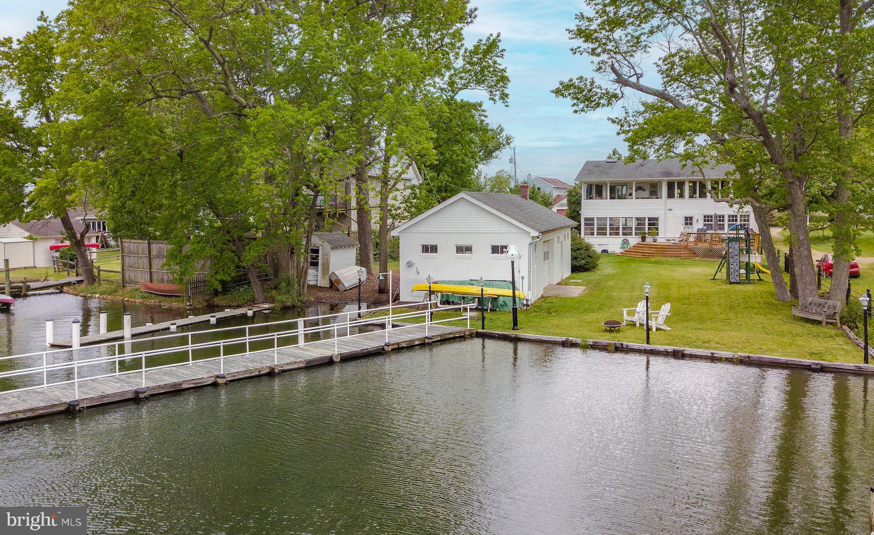 Charming Waterfront Cape Cod on Half Acre in sought after McKays Beach. Two (2) Piers with Water, El