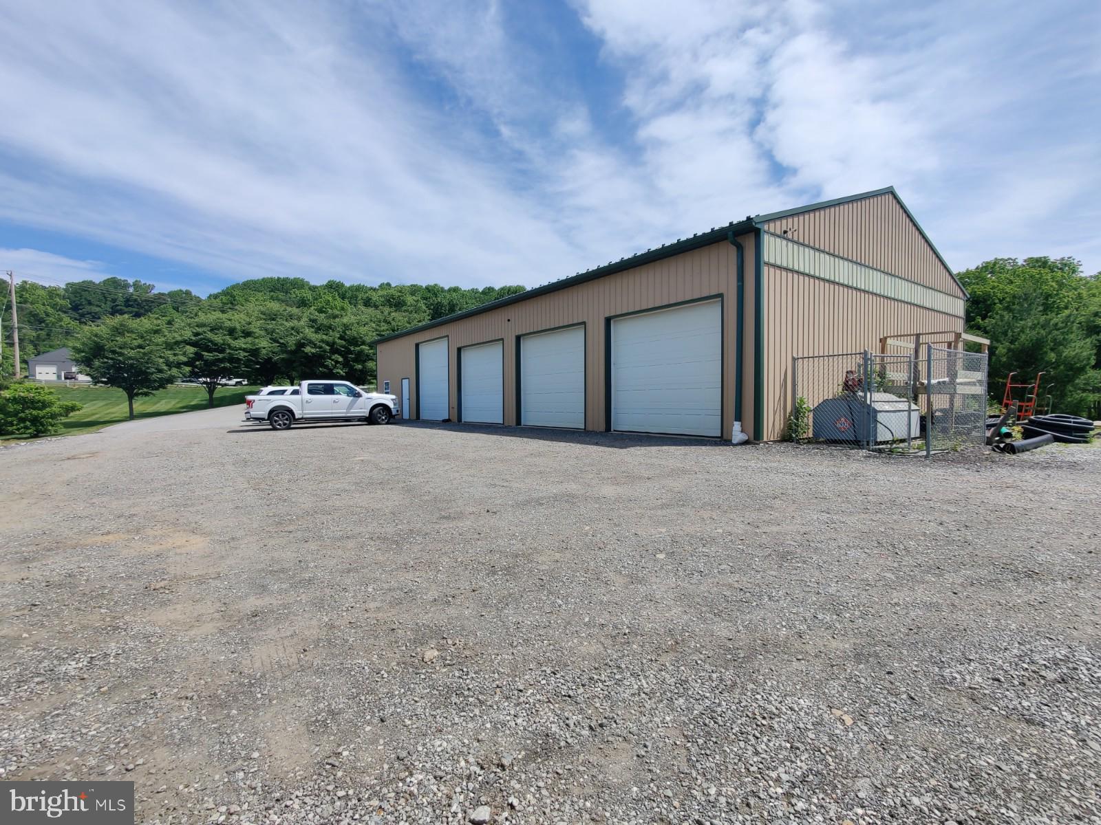 40 x 80 steel building on 1.3 acre commercial type zoning. 4 bays with overhead doors (1-12x12 &  3-10x12) 
Has cement floors throughout as well as electricity & water.  Large office area has 3 - 12x15 offices and AOA compliant bathroom.  1 - bathroom in shop area for employee use. Property has onsite water & septic. Diesel fuel tank has concrete floor base and is fenced in.  Alternative septic field exists. Presently used as a landscaping business shop.