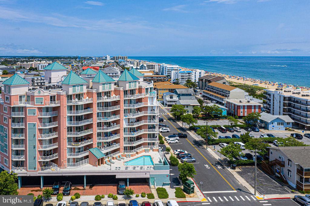 Stunning 4 bedroom / 3 bath ocean block condo in the desirable Mayfair Beach building. This spacious 2,100 s.f. condo is tastefully decorated and sold fully furnished. The kitchen features stainless steel appliances, granite counters, counter bar, and a large pantry. Next to the kitchen is a dining area that flows to a family room with a cozy fireplace, which is perfect for year round enjoyment. There are several entrances to the large wrap around balcony where you can enjoy peeks of the ocean and the nice ocean breezes. There are two primary suites, with one having direct access to the balcony. The third bedroom is off the hallway and has direct access to the 3rd full bath from the bedroom or the hallway. The fourth bedroom features a door that leads to the balcony. The HVAC is only 5 years old. This property offers abundant storage, including large closets, full laundry room with storage cabinets, large pantry and exterior storage. After an enjoyable day on the beach, you can take extra advantage of this units direct access to the pool from your private balcony. Great building with plenty of and close proximity to the beach, restaurants, entertainment, grocery stores and more! This condo shows pride of ownership & is ready for your immediate enjoyment. It's never too late to create special family memories!