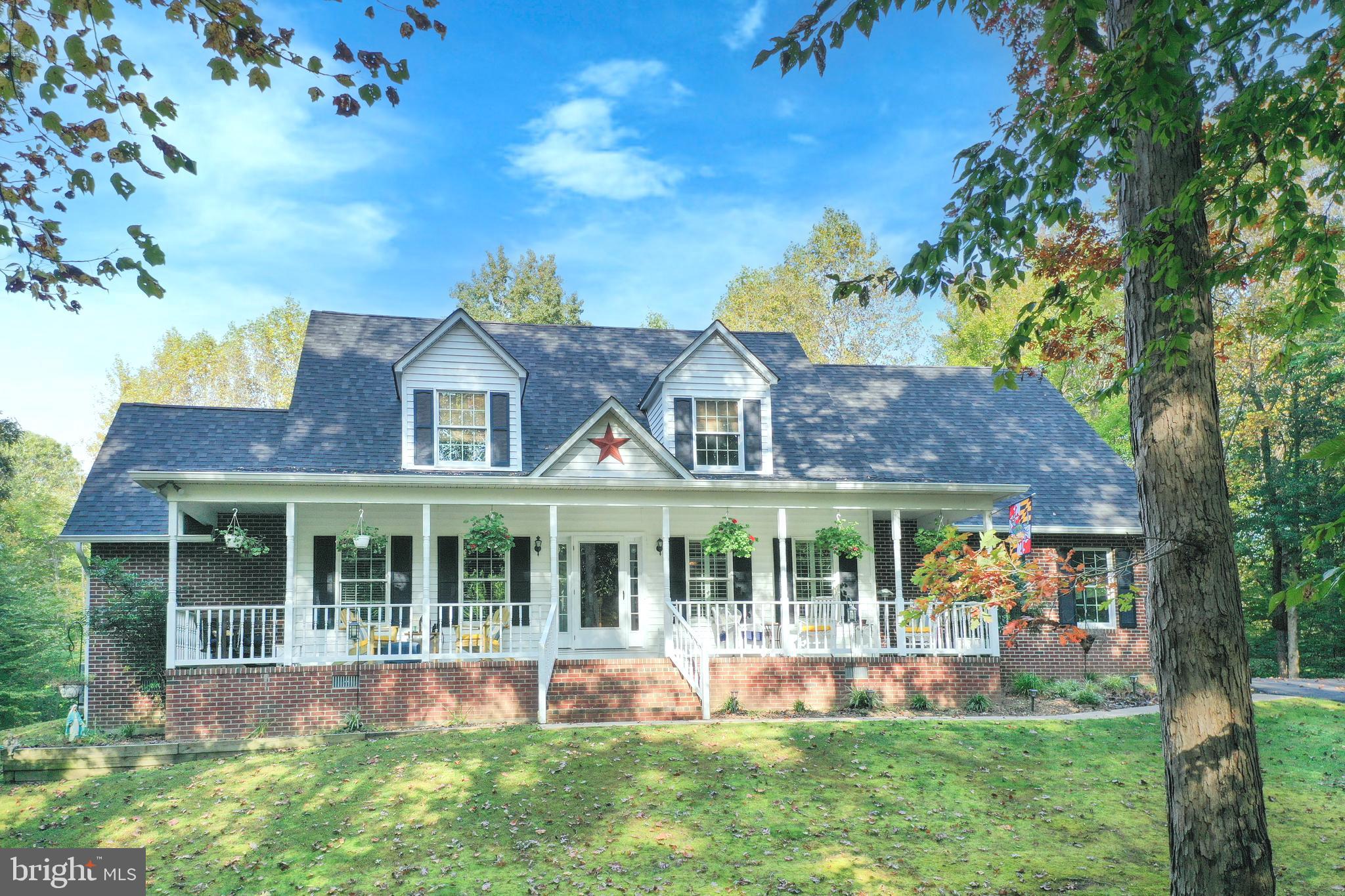 Beautiful and Charming!  Nestled on a private, picturesque 2+ acre lot surrounded by trees, this cus