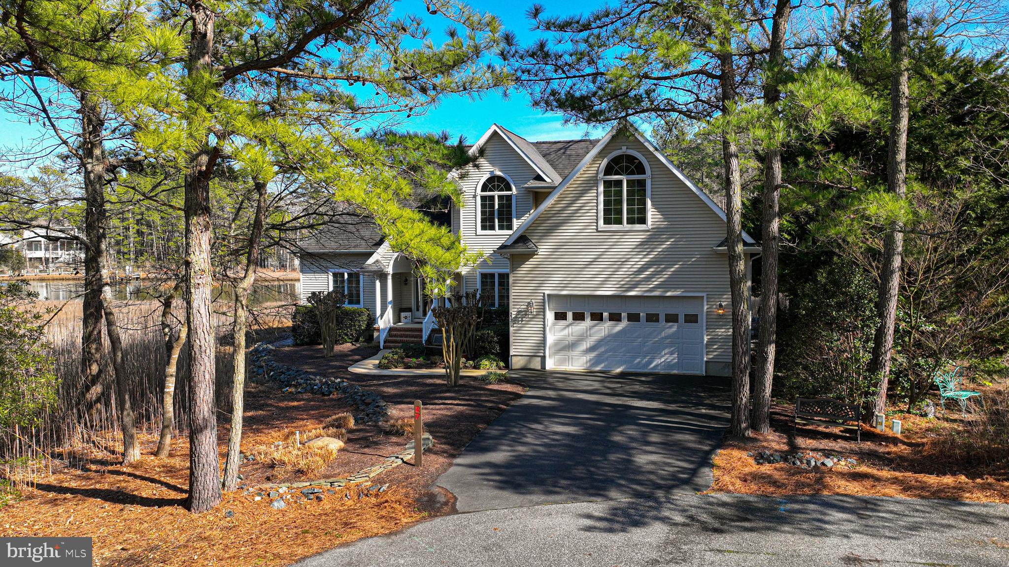 Enjoy tranquil views of Manklin Creek and marsh as you take in the natural beauty surrounding this waterfront home located in the Salt Grass Cove enclave of the Ocean Pines community.  The original owners worked with a reputable local builder (Beachwood) to create a custom design with great attention to detail and thoughtful planning. The living room is the heart of this home and offers water views, access to the screened porch and deck areas (overlooking the marsh & creek),  two sided fireplace, custom built-ins, and wet bar.   The adjacent kitchen with waterfront breakfast nook (w/ slider to deck) offers custom cabinetry & countertops, stainless appliances, pantry, and built-in work space.  The first floor owners suite offers water views, spacious en suite bathroom with double sink vanity, walk in shower w/ built-in shelves and seating & walk in closet with newer custom closet system.   The large dining room located by the front entry can double as a home office space and is equipped with additional outlets.  Upstairs you will find a 2nd floor landing that can serve multiple purposes, along with three guest rooms (one w/ private bath) and additional guest bathroom.  Plenty of storage throughout this home including thoughtfully placed eave storage access in multiple locations upstairs, oversized closets, and pull down attic access.  Walk through the laundry room to the attached garage where you can store your vehicles AND still have room for workspace, shelving as well as extra fridge & utility sink.  The oversized lot (.41 acre) is located on a cul-de-sac with water frontage on Manklin Creek, the perfect spot to launch your canoe or kayak.  This lot requires little yard maintenance thanks to lovely mulch beds, extensive hardscaping, rip rap perimeter on creek/marsh sides and natural marsh grasses that line the side yard.  Ocean Pines is a GREAT community-  the perfect place  for a second home OR year-round residence.  It offers low HOA fees ($896/yr) and a la cart