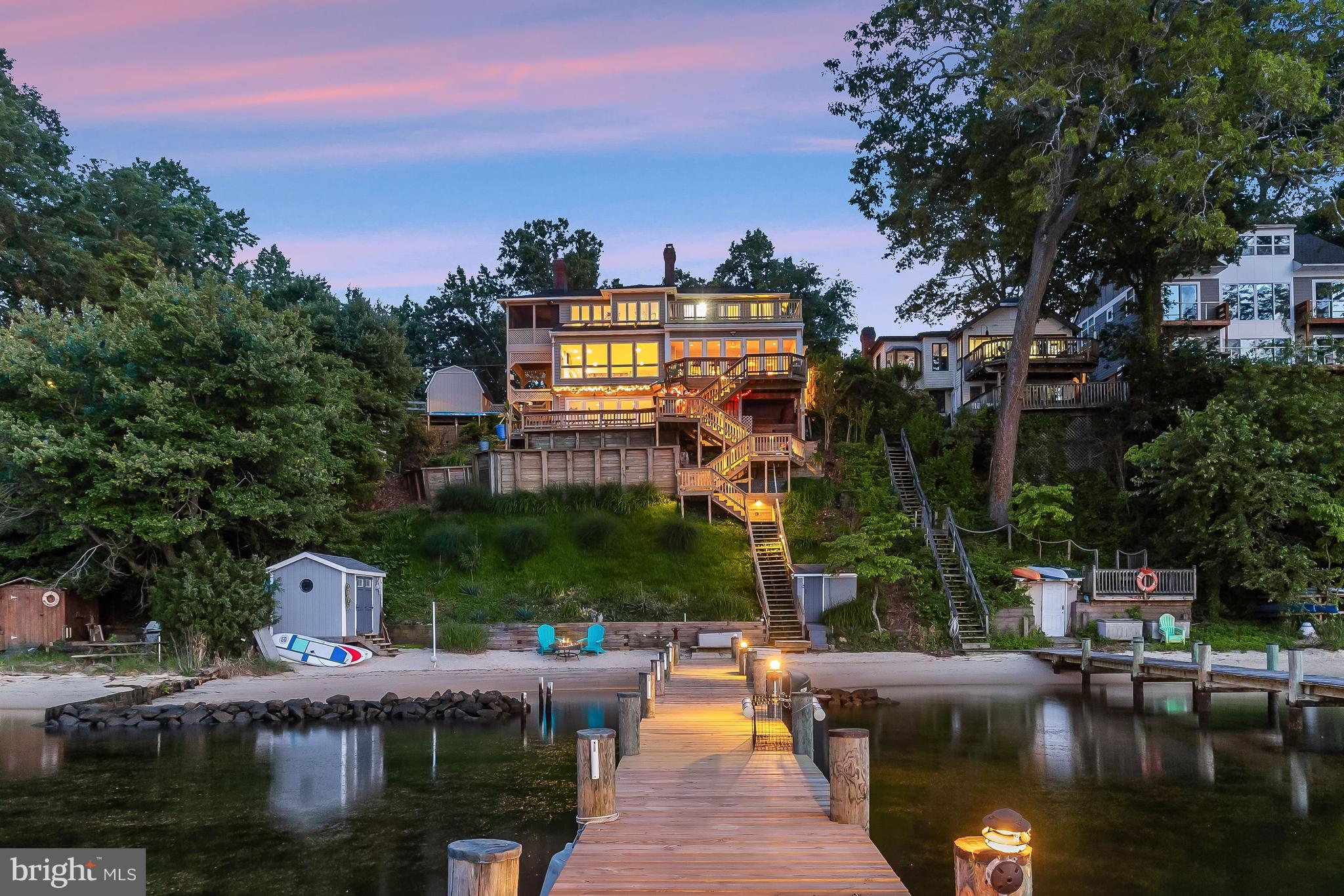 Enjoy the dream life of waterfront living in this three-level home highlighting its own private beac