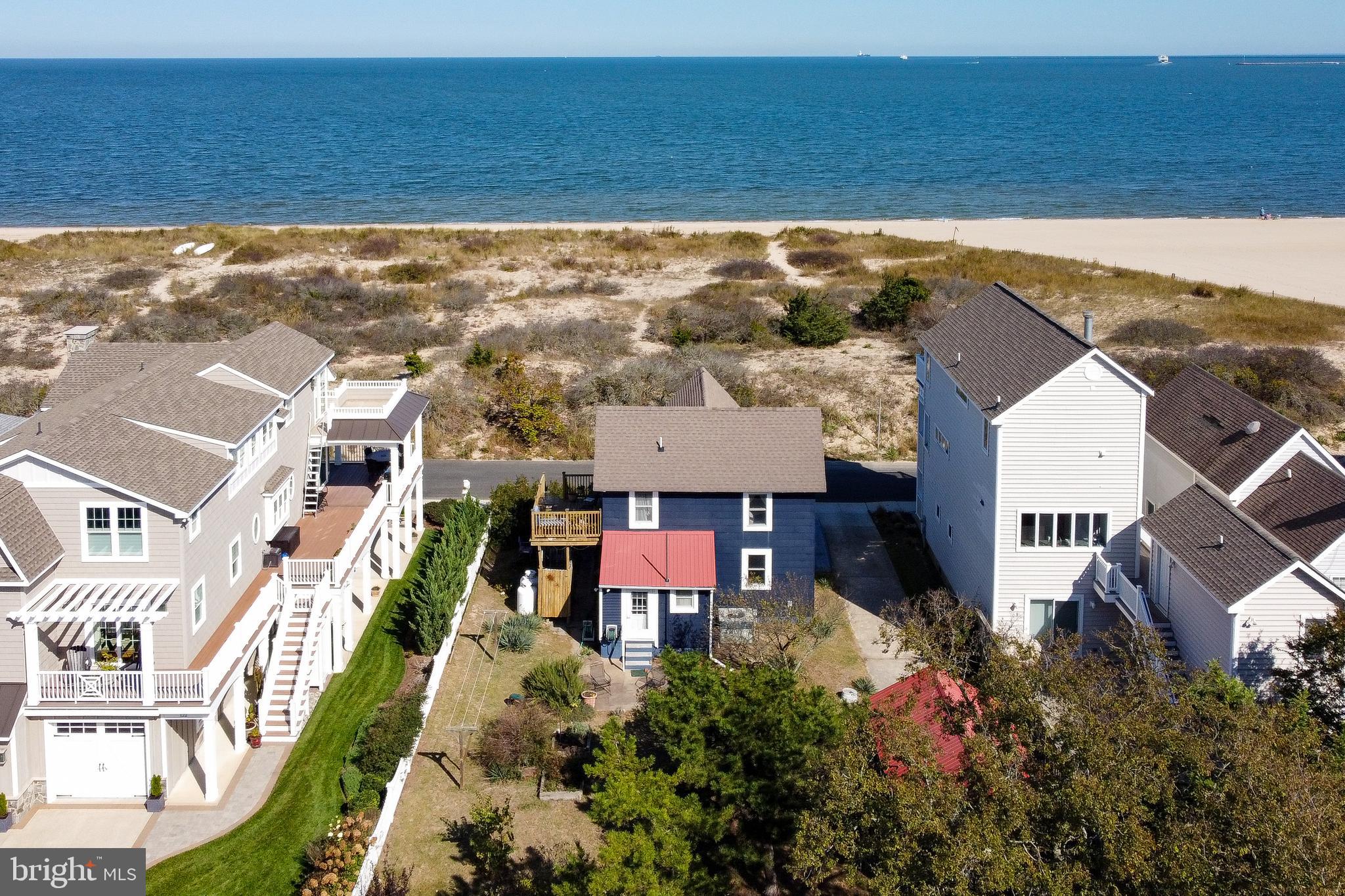 OVER 9,000 SQ FT OF BEACHFRONT PROPERTY - Take a front-row seat for panoramic sunrises & sunsets and catch the sea breezes over the picturesque dunes that buffer this home from the Delaware Bay. This early 1900s home on Lewes Beach has been lived in year round with some renovations over the last 20 years. The good bones of this house are an opportunity for those who may want to own a historic beach getaway or you could take this landmark location to build your beautiful new beach home. This parcel offers room for a 2 car garage & plenty of additional parking with frontage on both Bay Ave & Bayview Ave. Walk to dinner and shopping on picturesque Second Street, and on the way back stop for a treat at the famous Lewes Beach Dairy Queen, located just around the corner on E Savannah Rd.  Don't forget you can bike to nearby Cape Henlopen State Park, Junction & Breakwater, and Gordons Pond Bike Trails. Make 118 Bay Ave your beach dream come true!