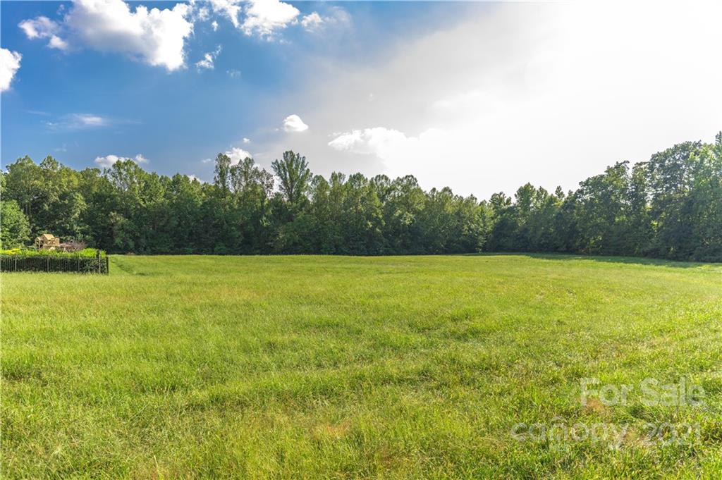 New Salem Estates is a top quality subdivision in the Cool Springs area of Statesville.  County water and septic.  Utilities are stubbed out at the lots.   Large lots provide gracious spacing between homes that are/ and will be, valued between $450,000 to $550,000 and up.  CC&R's and architectural review restrictions are to protect property values.  Plans to be reviewed by owner prior to acceptance.  Lot 12 is one of the very largest lots in the subdivision.  Photographs are of the total community, various views. Plenty of room for in-ground pools and outdoor entertainment areas.  Homes are to be brick, stone, stucco, and hardie board.  Several are already erected and prospective buyers are encouraged to take a look at this lovely community.  See drone footage in MLS link.  Complete price list of all available lots can be obtained from Listing Agent.
