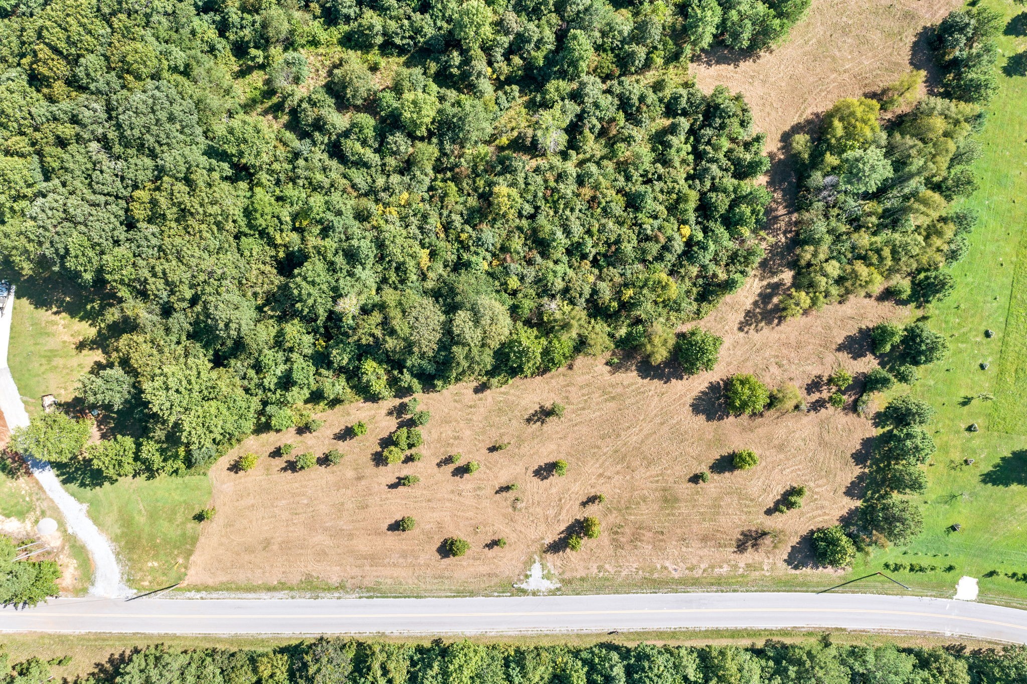 Are You Looking for Open Space or to be Nestled Under the Trees?  This Piece of Paradise in Indian Mound Has It All! 12.05 Acres with Over 400 ft of Road Frontage Per Boundary Survey dated 11/2020 - Approximately 30 minutes to Downtown Clarksville & Easy Access to Gate 10 of Fort Campbell - Seasonal Stream - Sellers put in Culvert for Easy Access to the Property